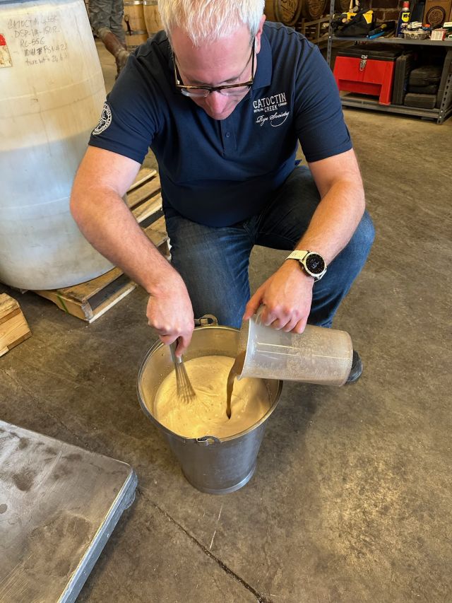Image of individual making whisky.